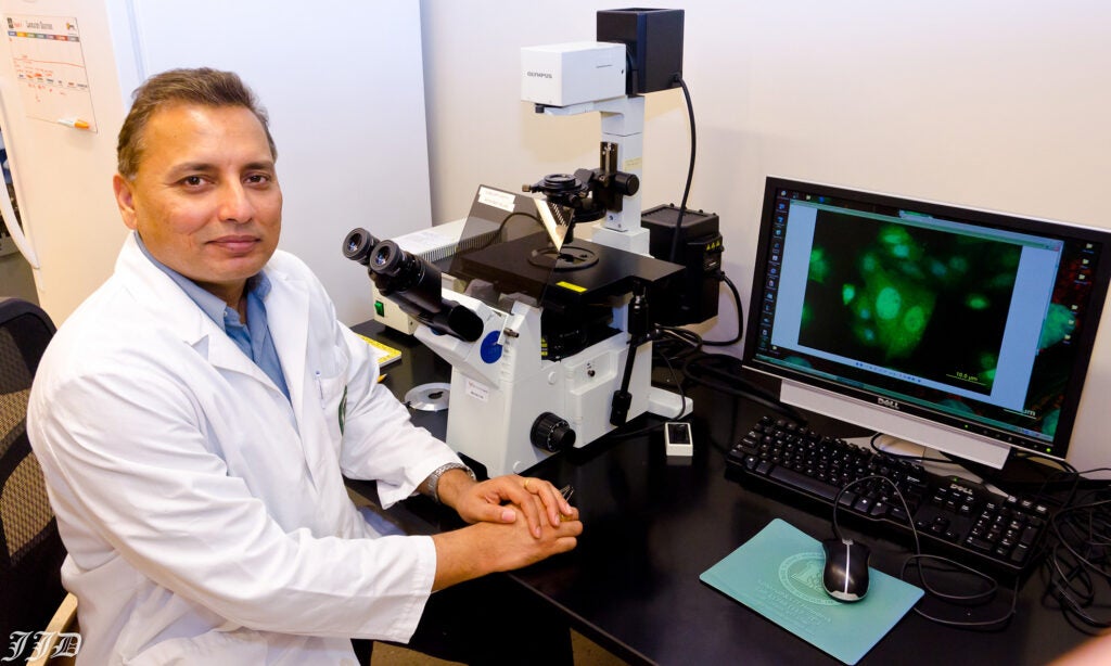 Dr. Jagan Valluri, professor of biological sciences and co-inventor of ChemoID® smiles for a photo in a lab