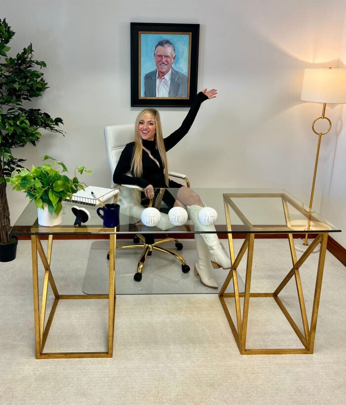 Jamie Lima sits at Dolly's desk in her office in Sevierville, Tennessee