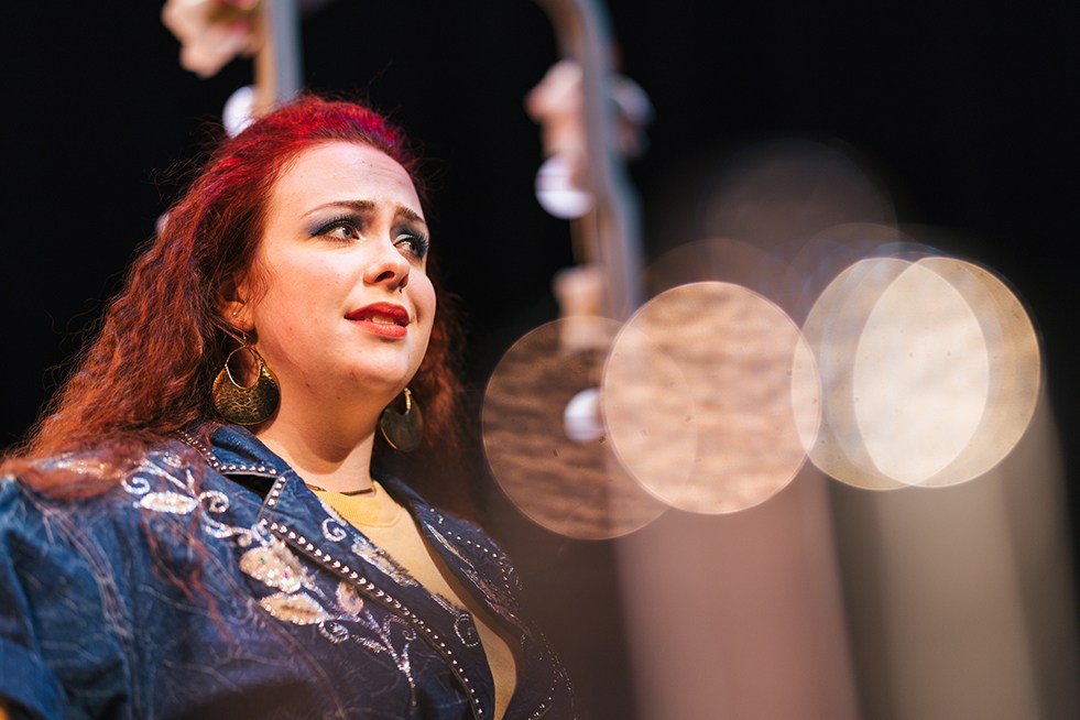 Kendra Williams acts out the role of Truvy on stage.