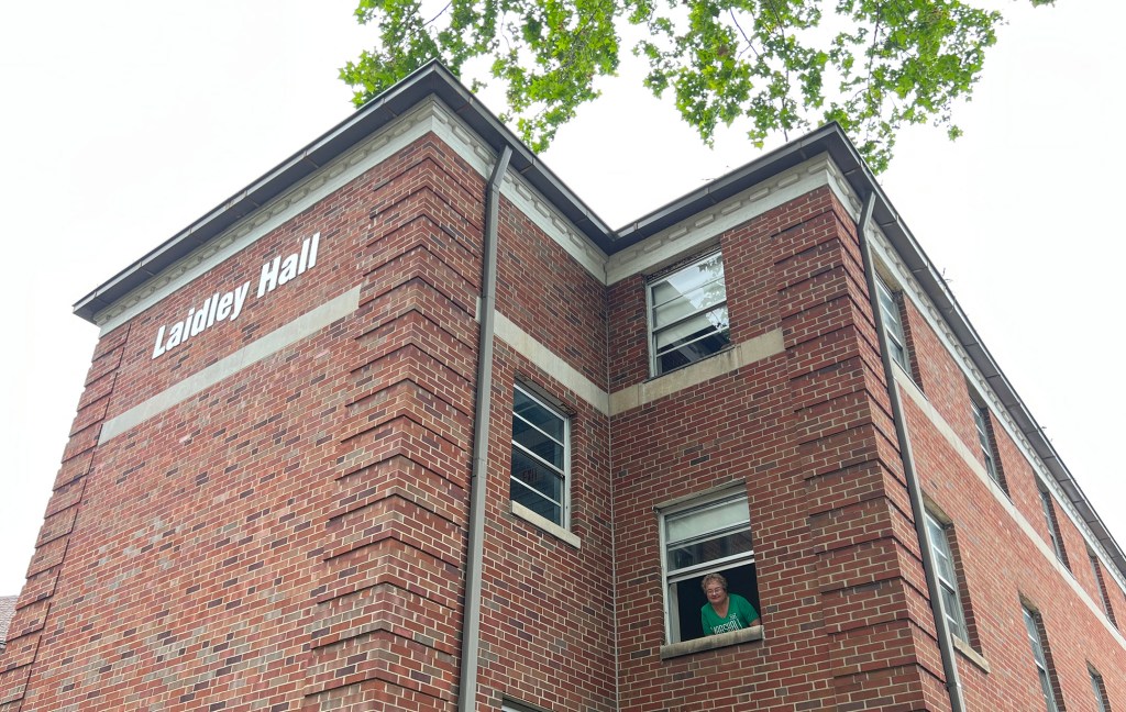 Charlotte leans out of her freshman dorm window during a visit to Laidley Hall