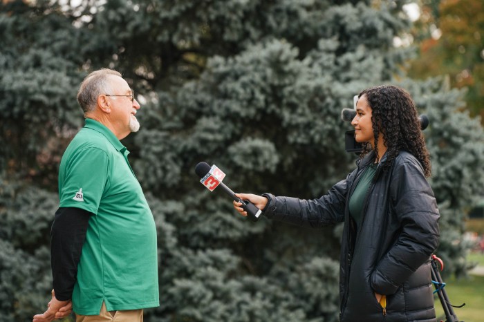 Roger Barker, a member of the USS John Marshall Reunion Planning Committee is interviewed by a local news reporter