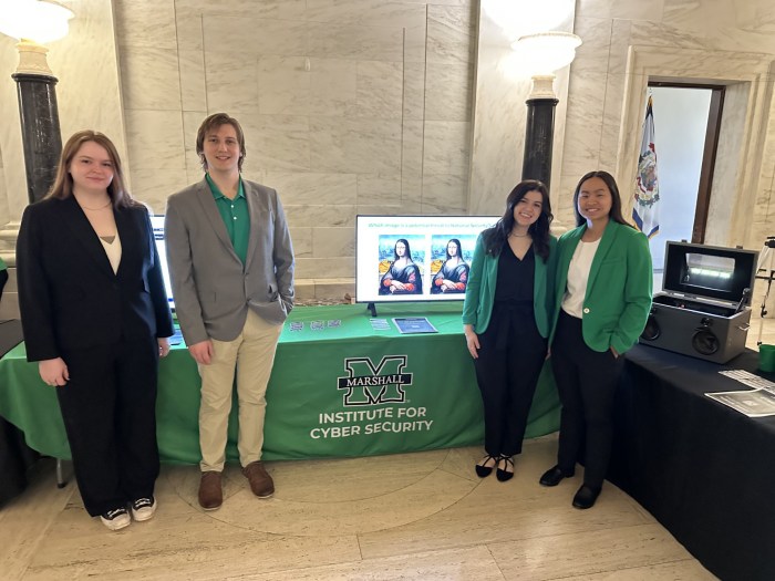 Hanna Shrout with Classmates at an Institute for Cyber Security event table