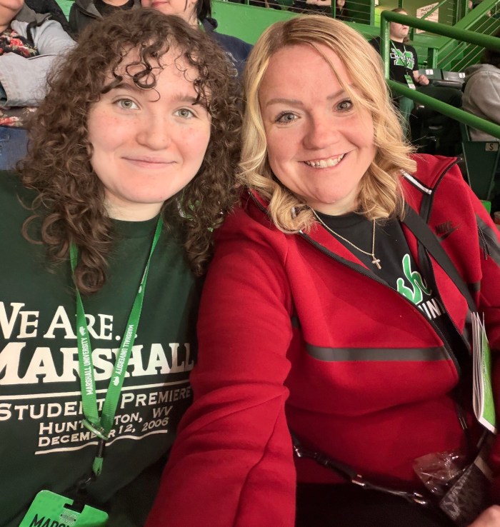 Payton and her mom smile for a selfie during a Marshall University basketball game