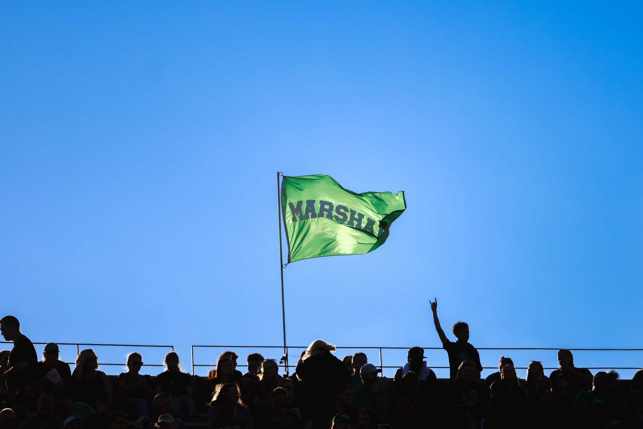 Marshall flag at the top of the Joan C Edwards stadium with fans in the foreground