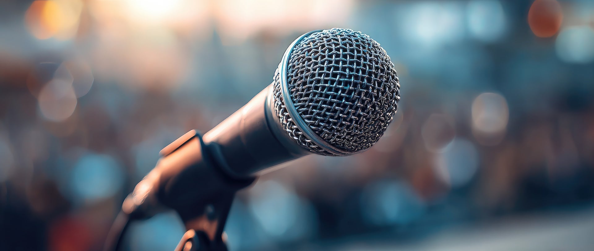 Image of Microphone with crowd blurred in the background