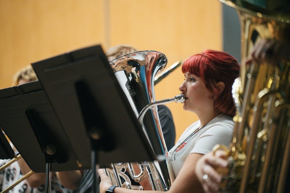 Image of student playing an instrument.