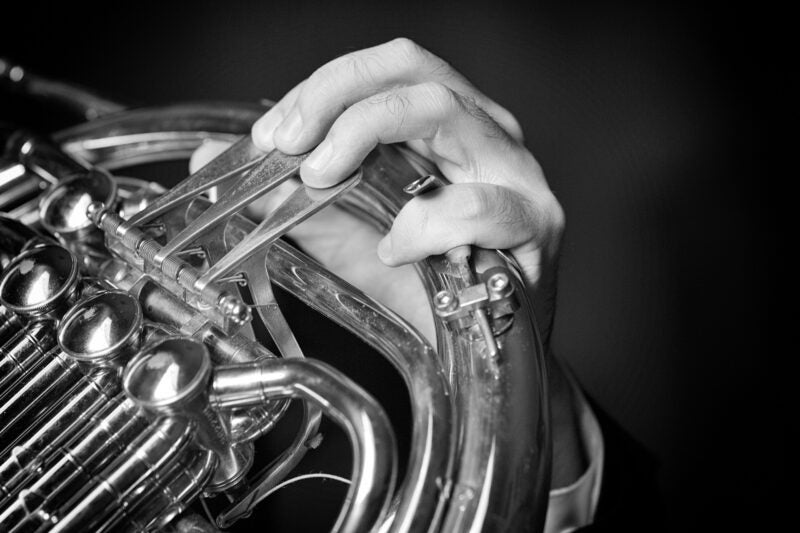 Close up image of hand playing an instrument