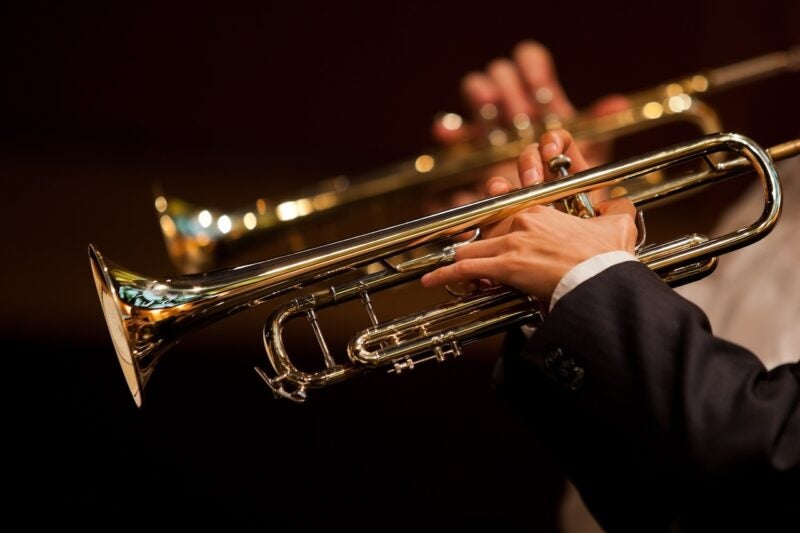 Image of a hands on trumpets.