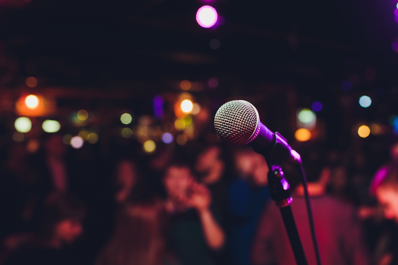 Image of microphone looking at the audience.