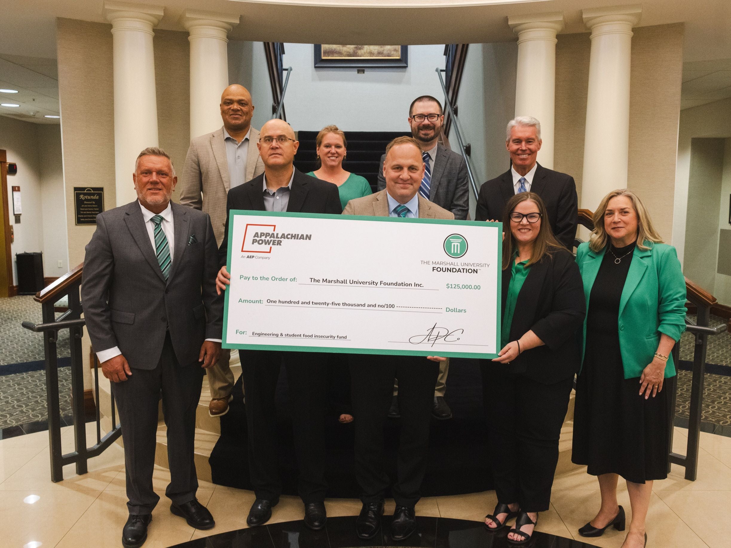Group of people holding an oversized check from AEP.
