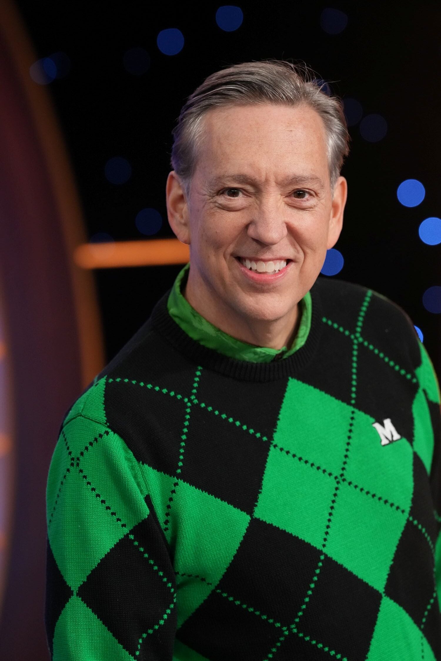 Man in a green and black sweater