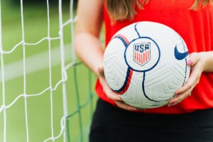 A close-up image of Skye Reymond holding a soccer ball
