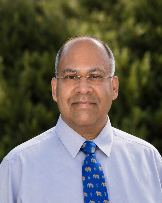 Man in dress shirt and tie with glasses