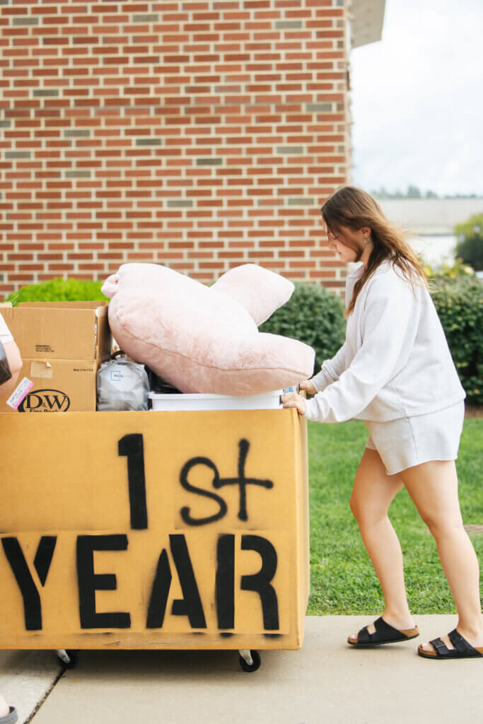 Female student moving in to residence hall.