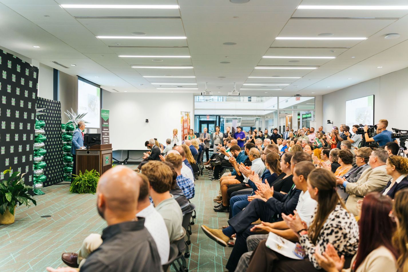 Crowd of people listening to a speaker