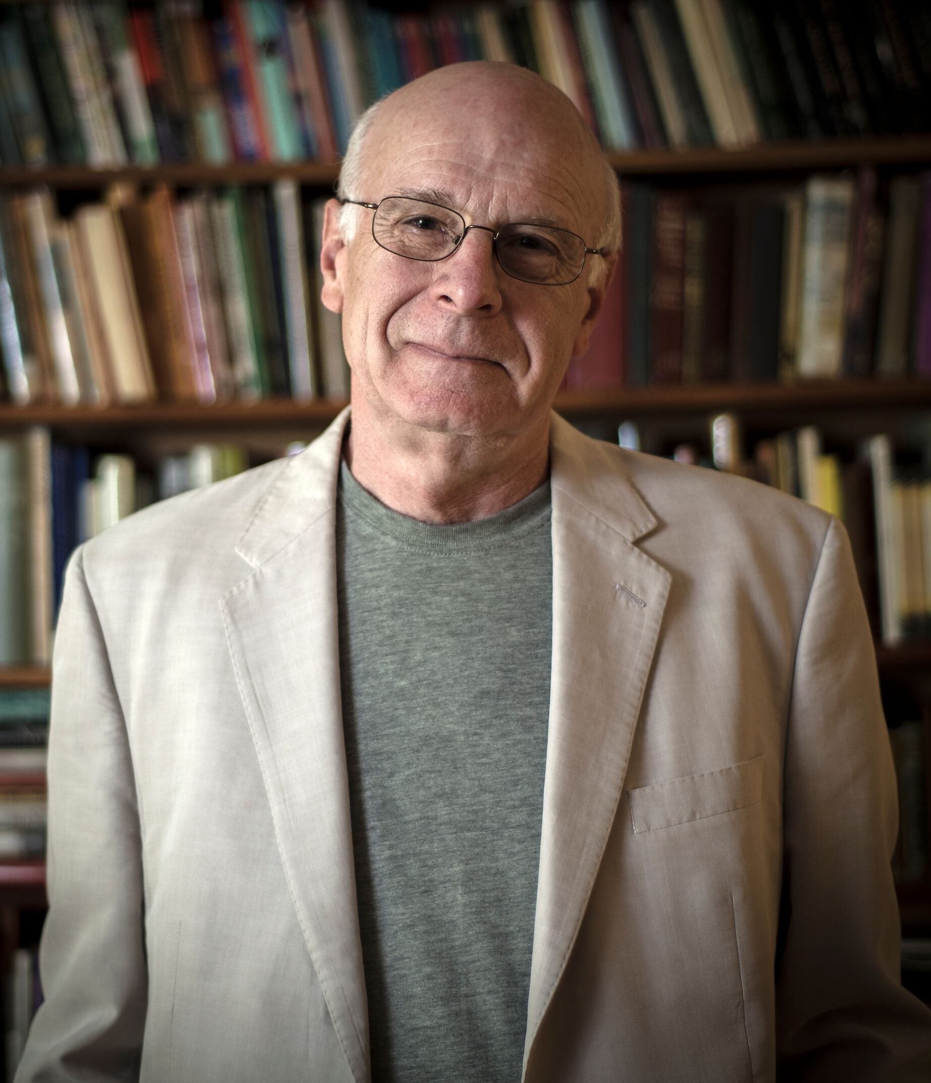 Man with glasses and beige sport coat.