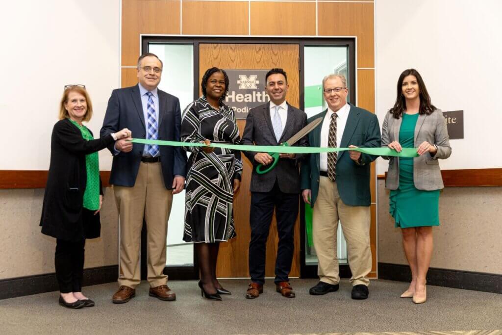 Marshall Podiatry Ribbon-Cutting with green ribbon