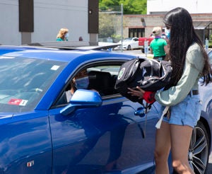 Anisha Valluri handing out backpack