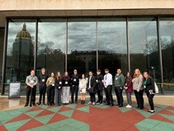 Students posing for a picture in front of a building