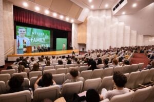 Image of students in a high school auditorium looking at a stage