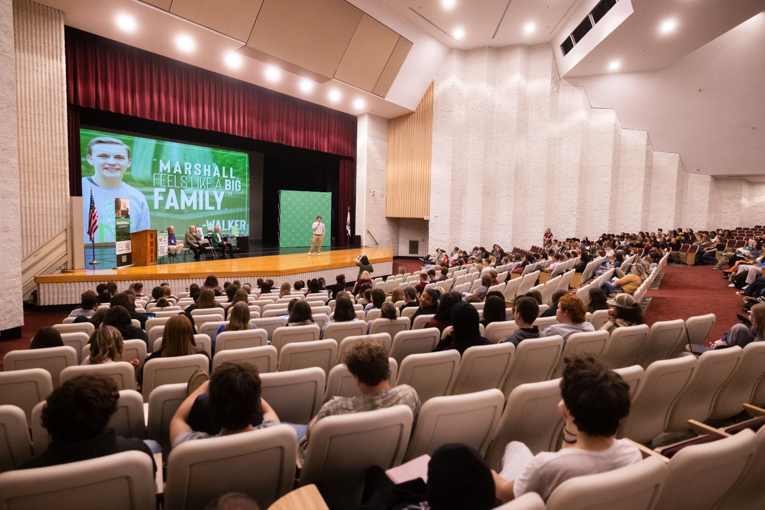 Image of students in a high school auditorium looking at a stage