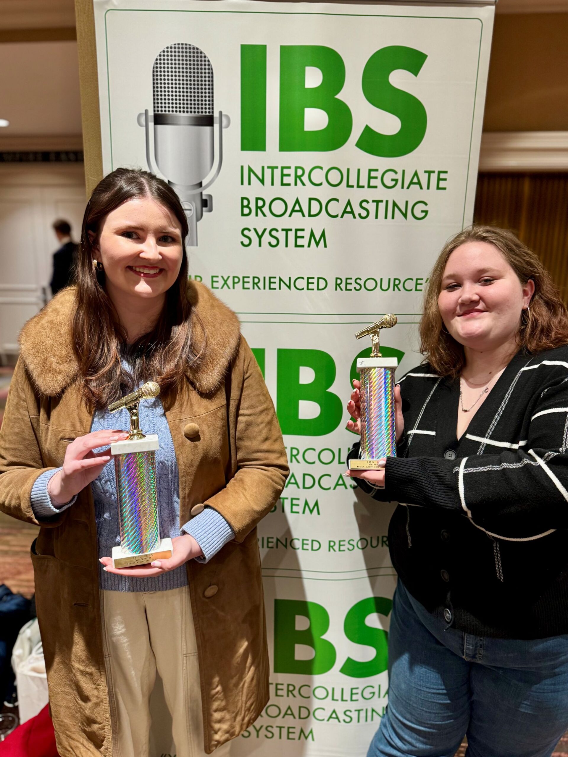 Two female students accepting an award