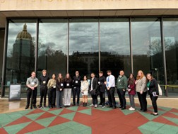 Students posing for a picture in front of a building