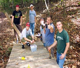 Group of students in the field working on a forest trail