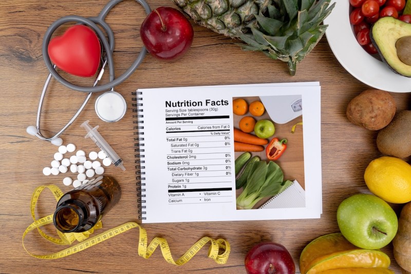 Image of nutrition facts sheet surrounded by food