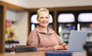 woman smiles on computer