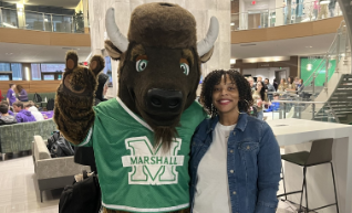 woman smiling next to Marshall bison