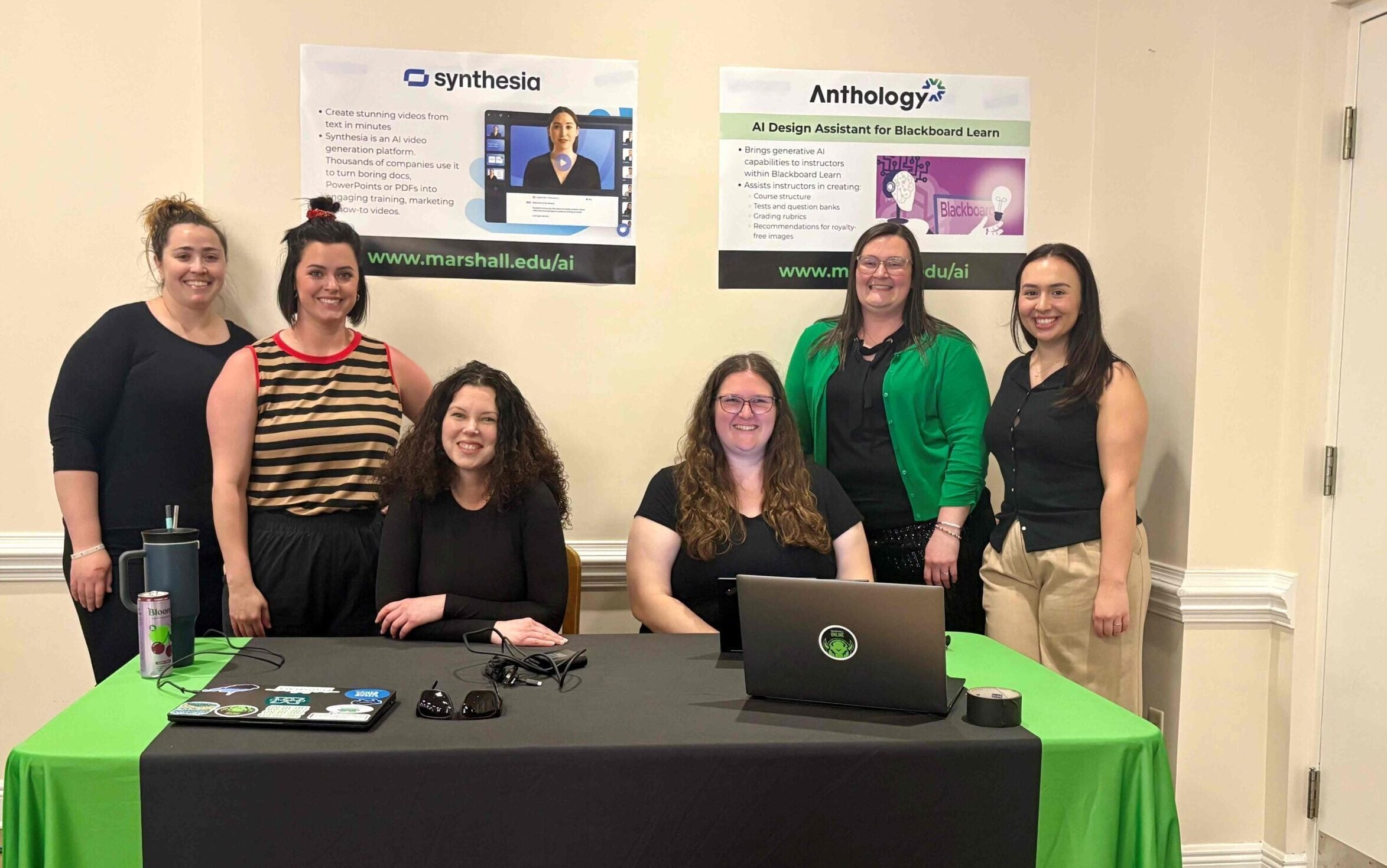 6 women gathered around a table that says Marshall Online