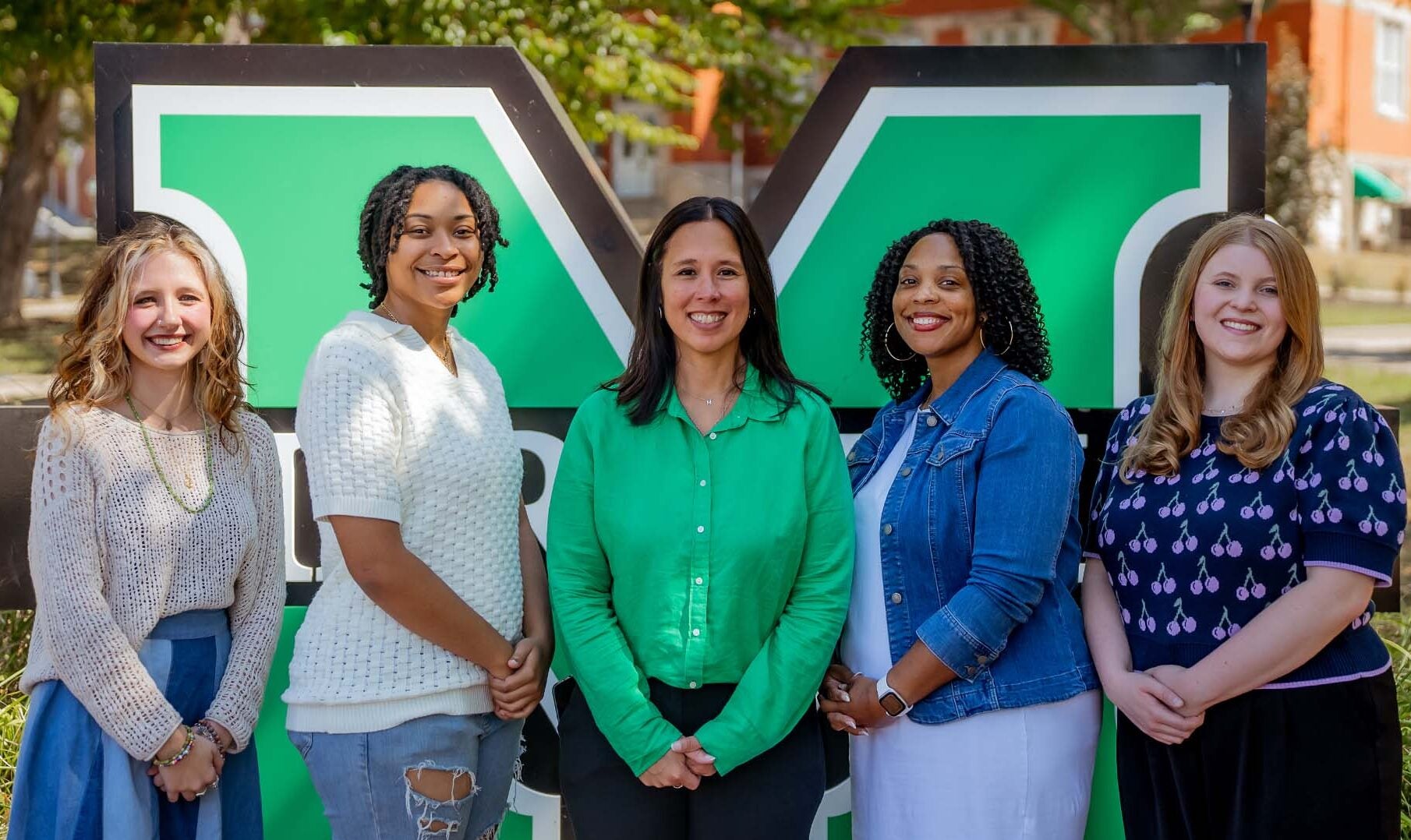 Marshall Online Student Engagement Staff photo, 5 women smiling, standing outside.