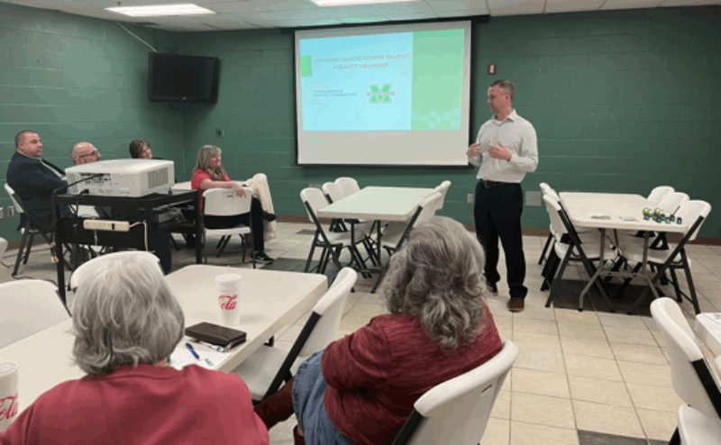 man presenting to room of people