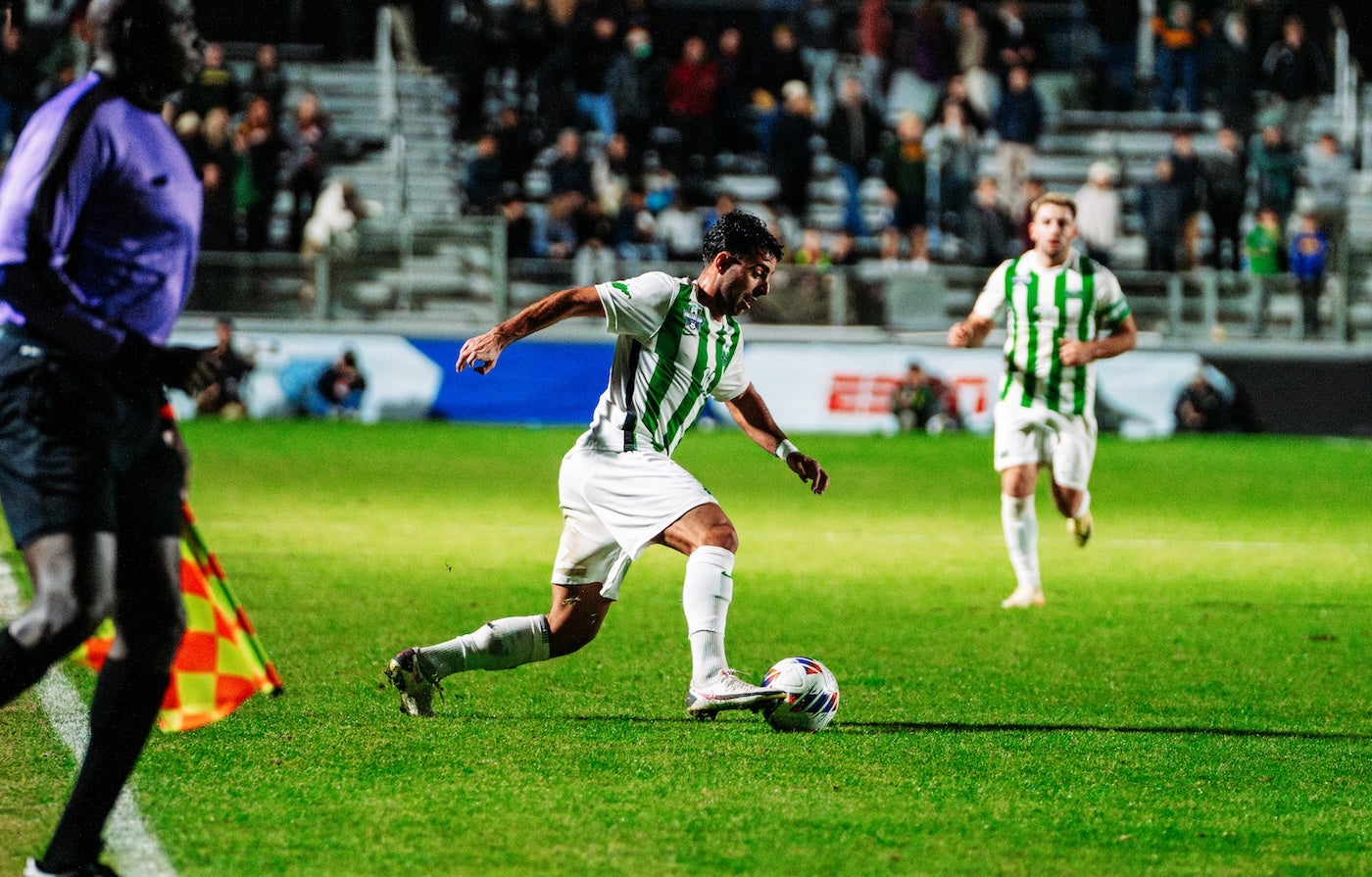 Marshall soccer player kicking a ball in a game