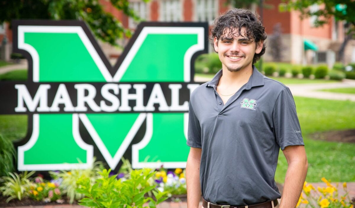 Criminal Justice student standing by block M on campus