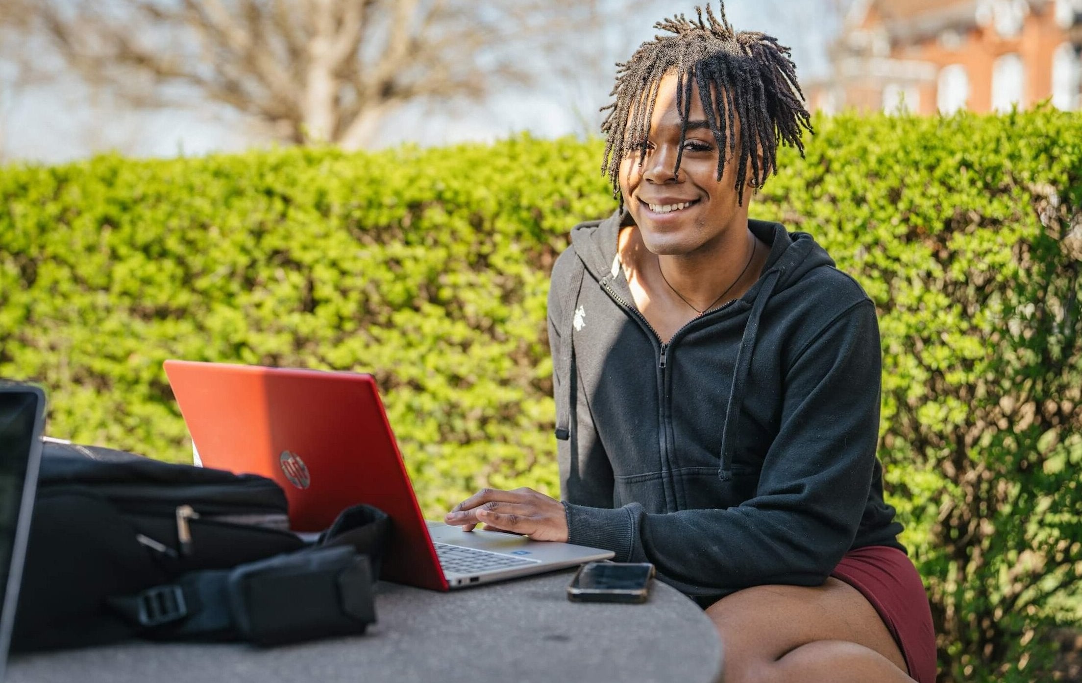 student working on a laptop outside