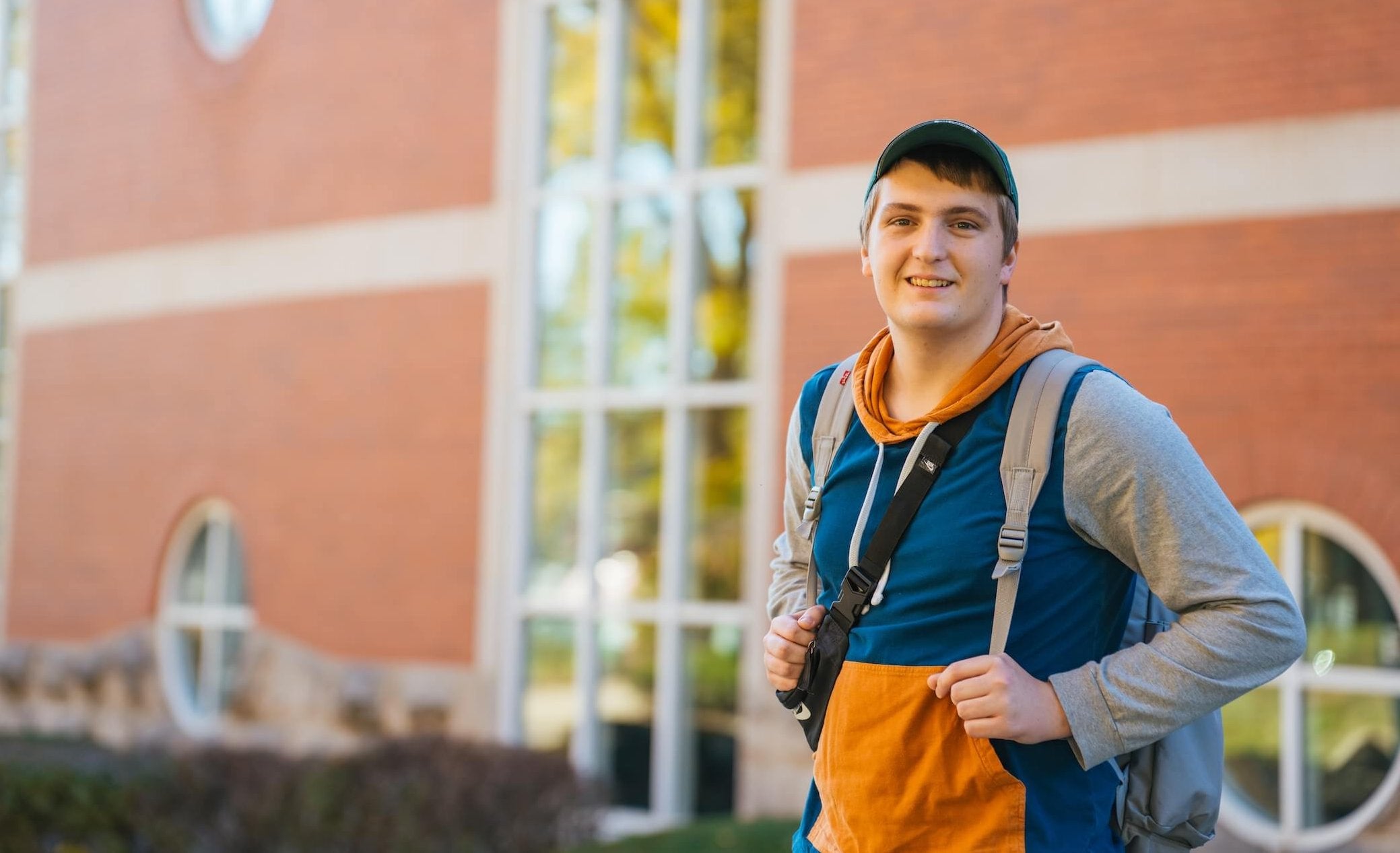 student with a backpack standing in front of Drinko Library