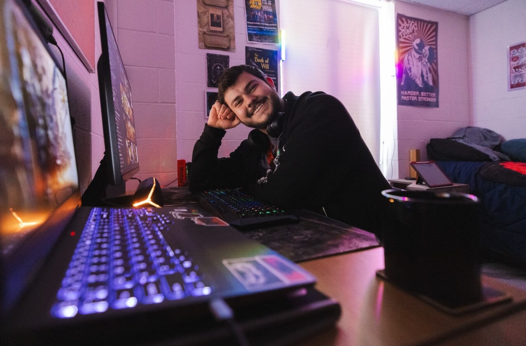 student smiling at desktop computer