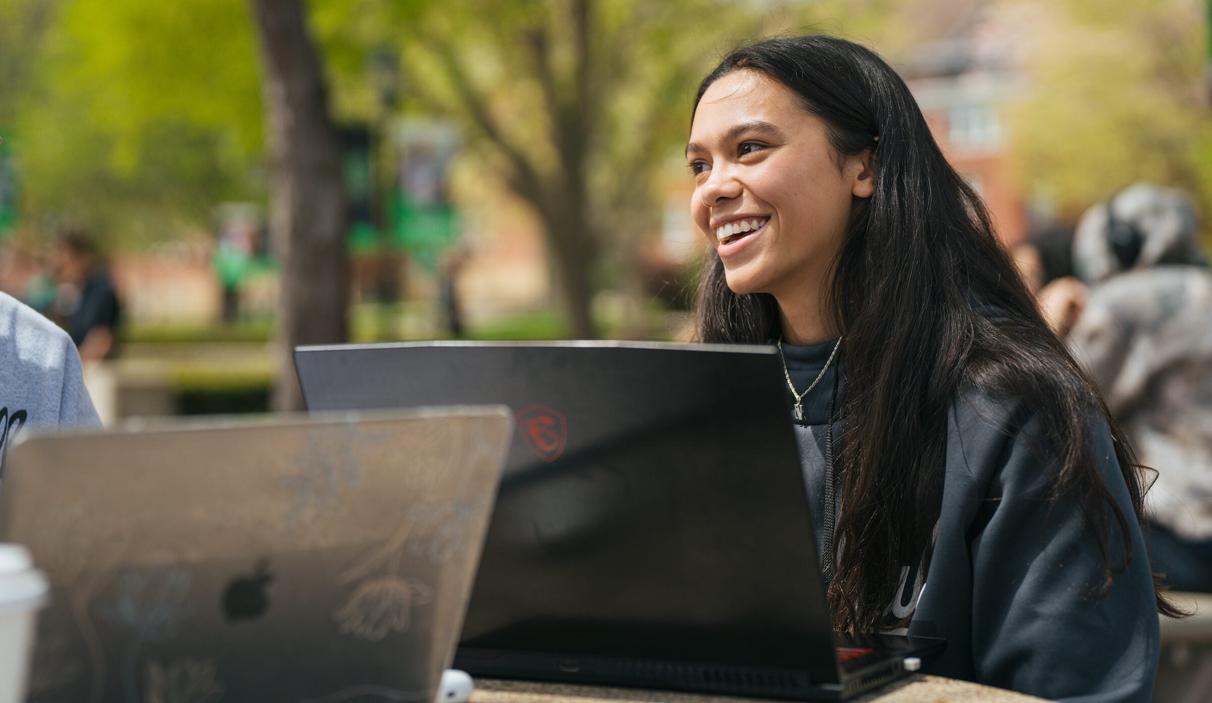 student working on a laptop outside the Memorial Student Center