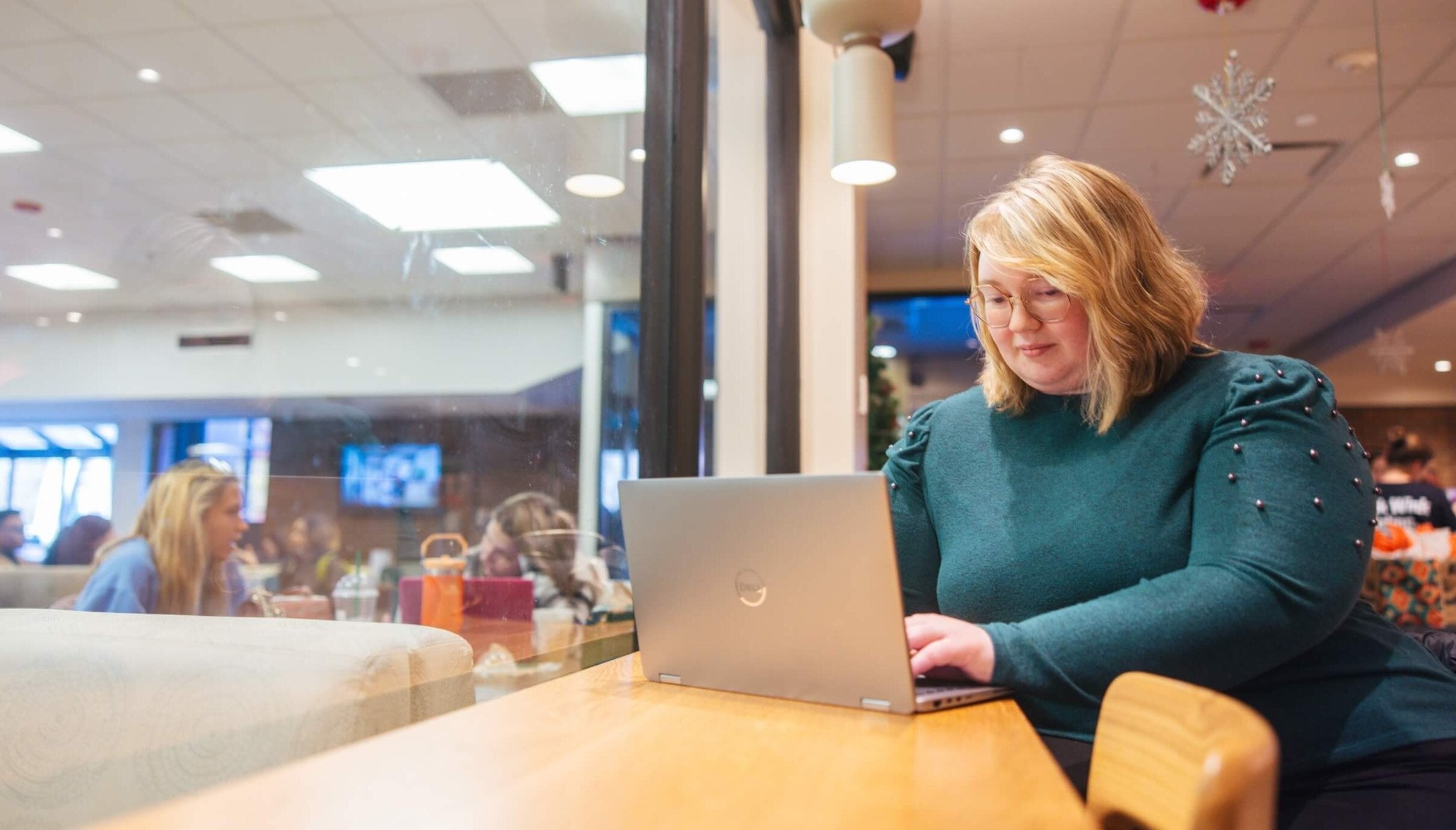 student working on a laptop at Starbucks