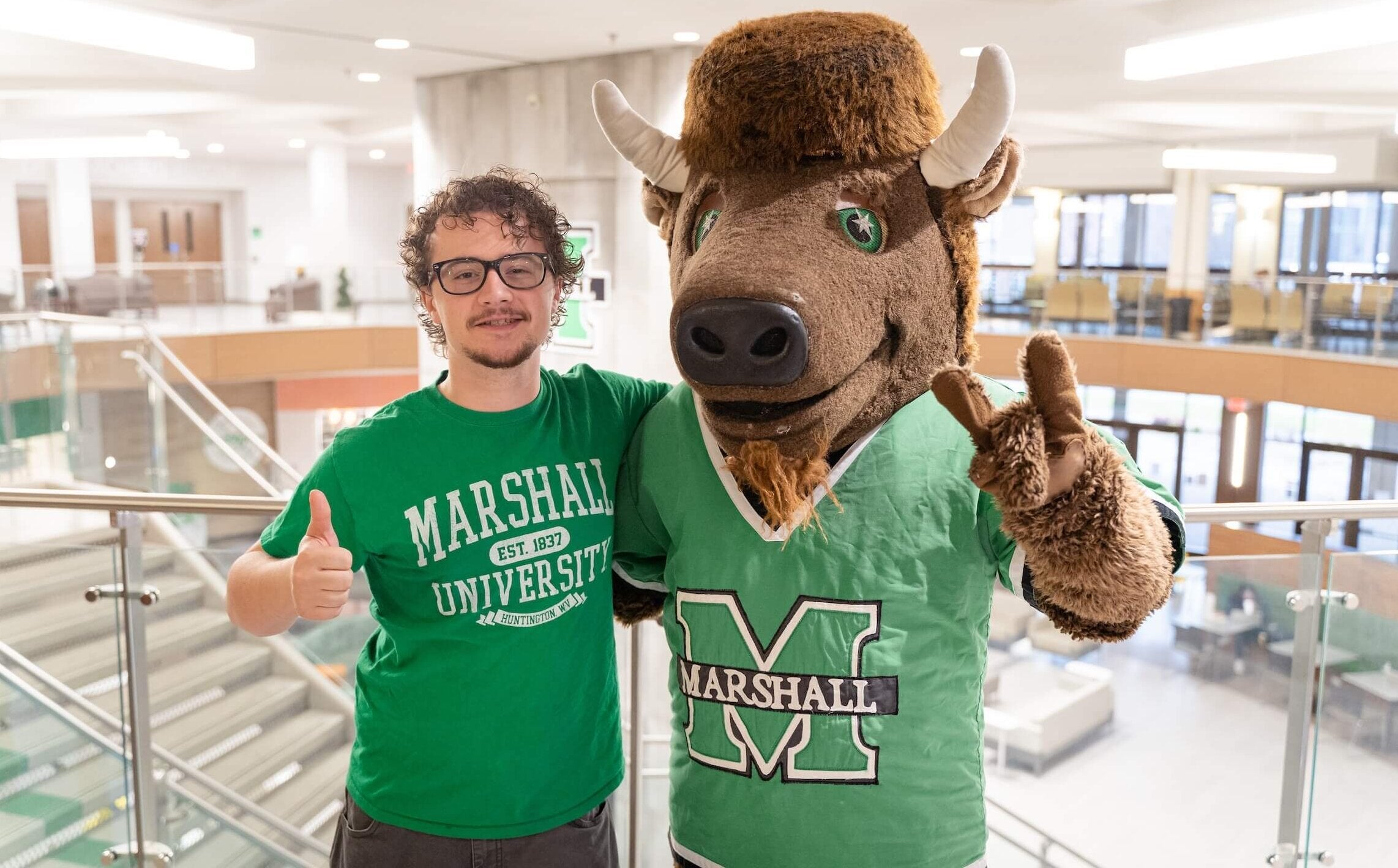 Geography student smiling with Marco in the student center