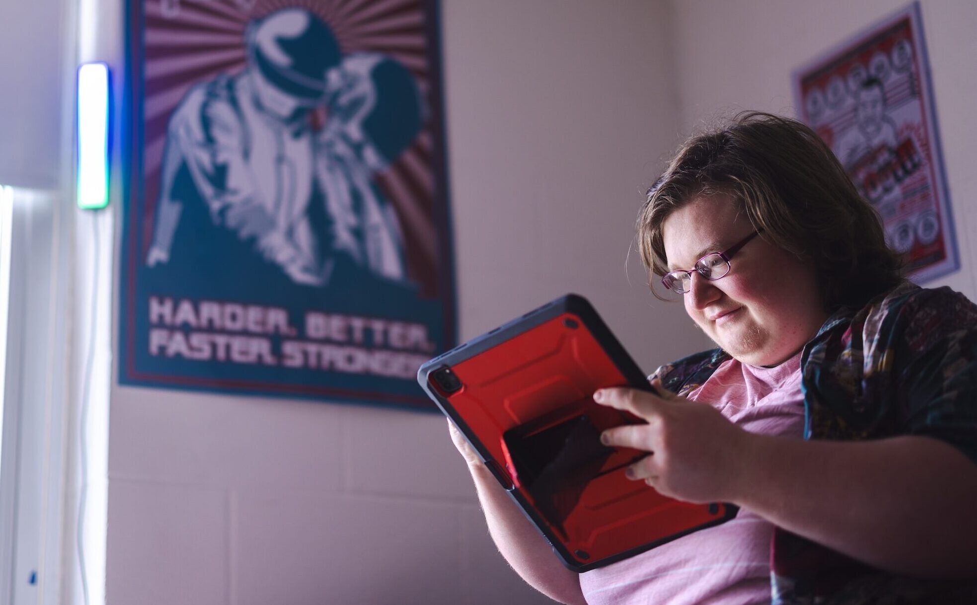 student working on an ipad in a residence hall room
