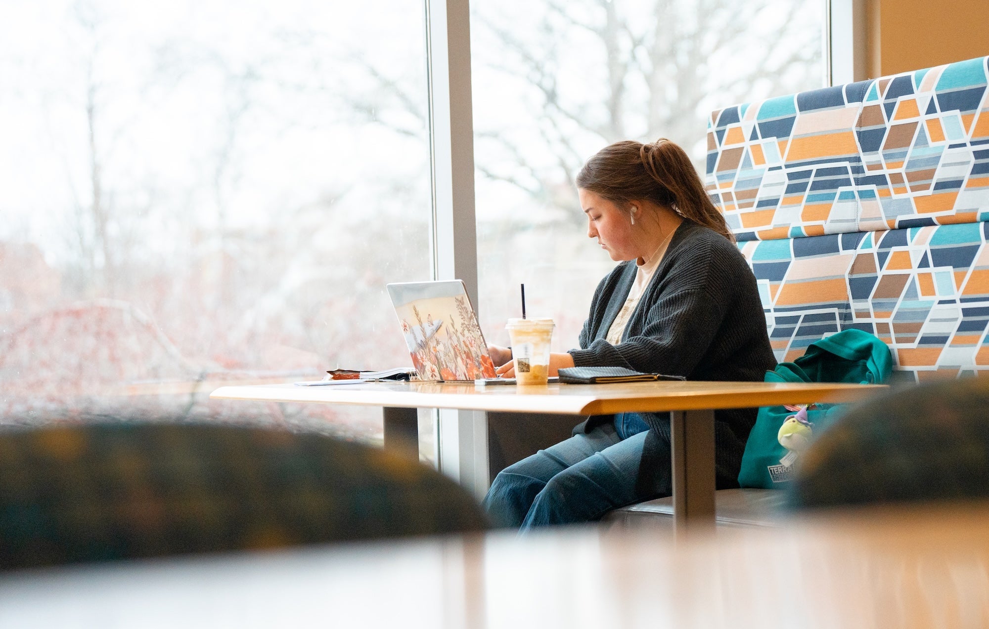 student working on a laptop in the library