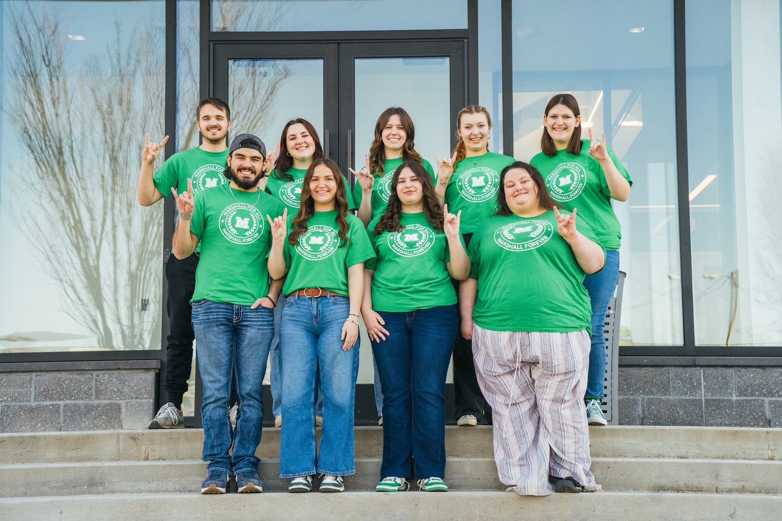 group of Marshall For All students standing on the steps of the school of business building showing the 