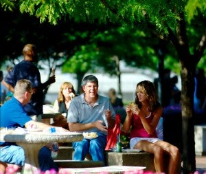 Parents laughing at lunch on the plaza