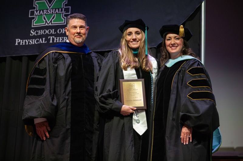 photo of two professors with a PT student at graduation