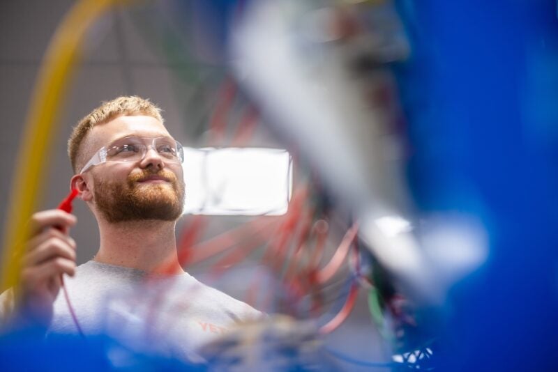 person working with circuitry in an advanced manufacturing setting
