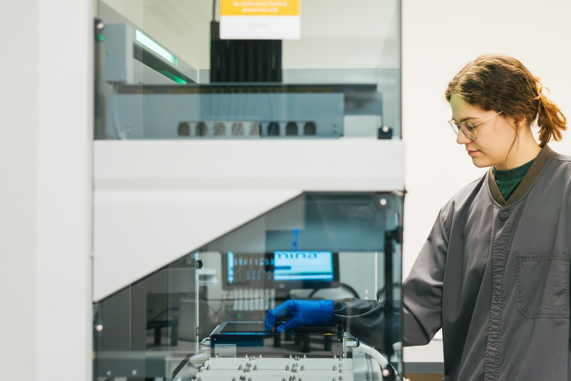 person working on a lab machine in the forensic science center