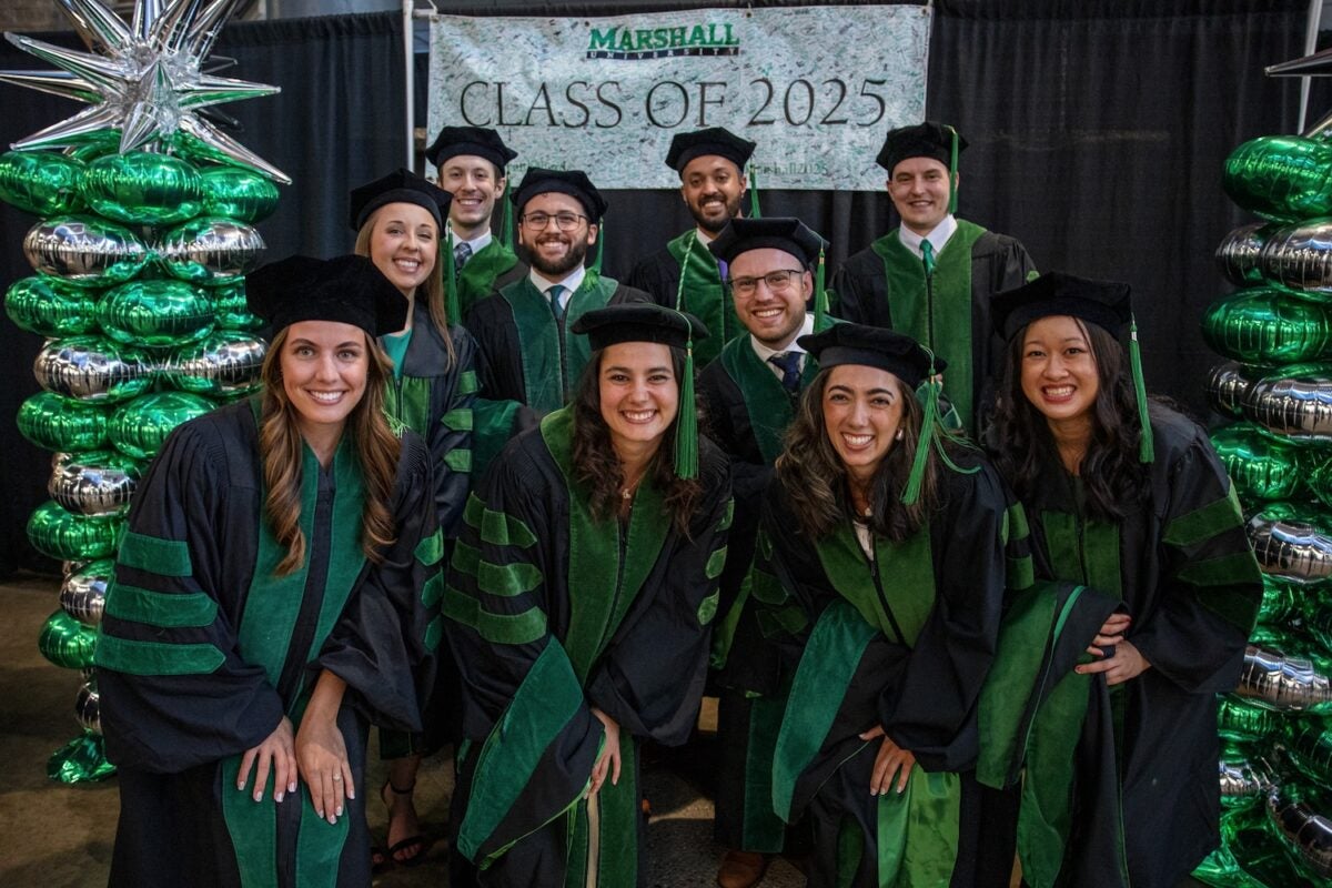 group of medical students at graduation smiling at the camera